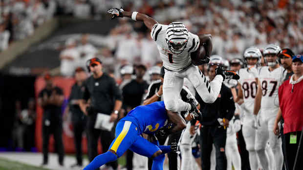 Sep 25, 2023; Cincinnati, Ohio, USA; Cincinnati Bengals wide receiver Ja'Marr Chase (1) leaps over Los Angeles Rams safety Russ Yeast (2) on a catch down the sideline in the fourth quarter of the NFL Week 3 game between the Cincinnati Bengals and the Los Angeles Rams at Paycor Stadium. Mandatory Credit: Sam Greene-USA TODAY Sports